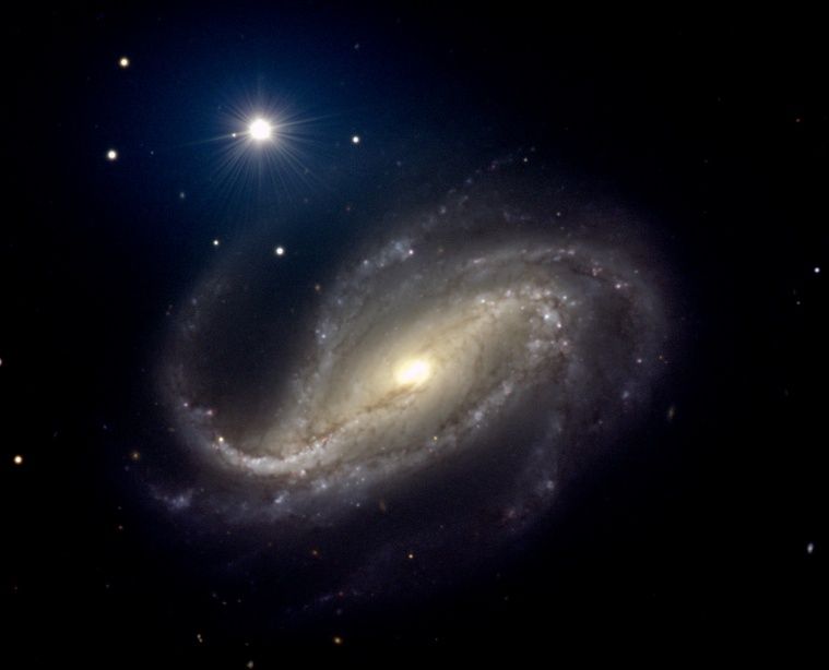 NGC 613: Spiral of Dust and Stars