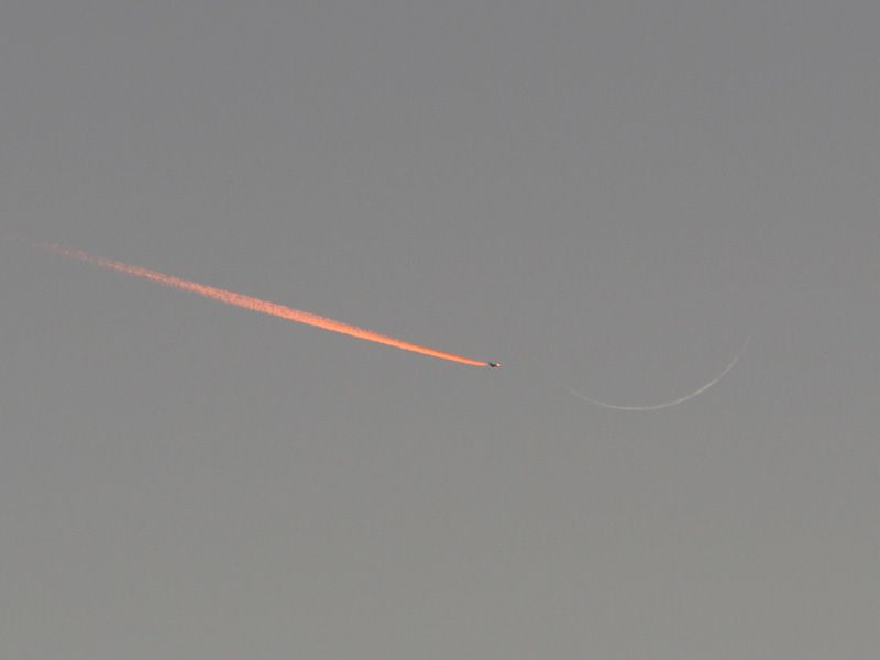 Jet Approaching a Crescent Moon