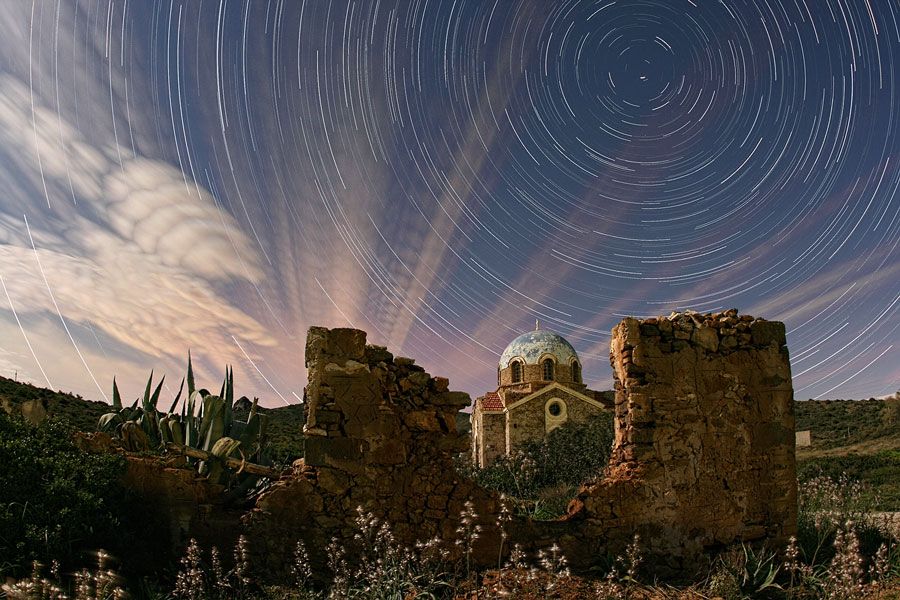 Illuminated Cloud Trails Above Greece